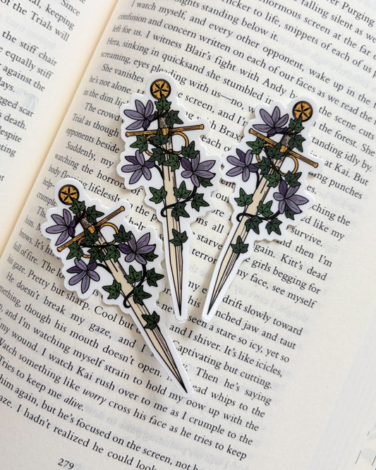 Three decorative brooches with floral designs on an open book
