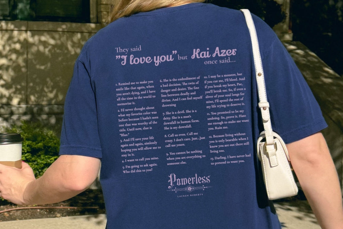 Blue t-shirt with 'Powerless' quotes by Lauren Roberts, worn by person holding coffee