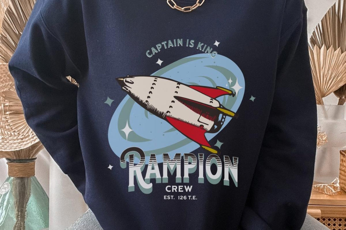 Navy sweatshirt with retro rocket ship, 'Captain is King' and 'Rampion Crew' graphic print.