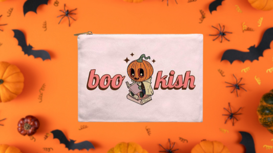 Halloween book pouch with pumpkin character reading, surrounded by bats and pumpkins