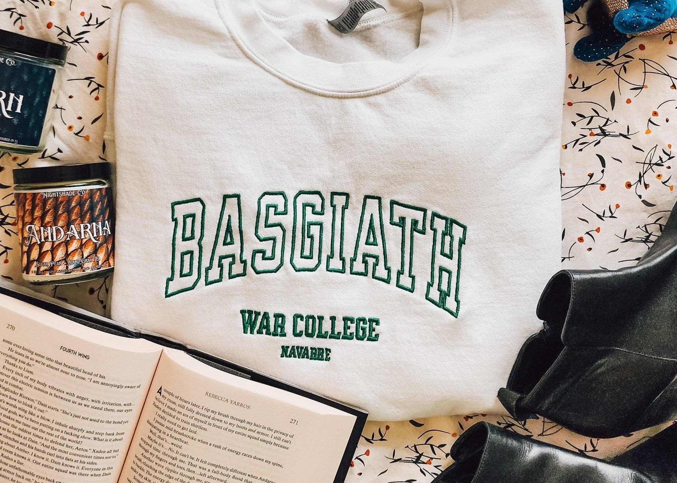 Basgiath War College sweatshirt with book, candles, and boots on patterned fabric