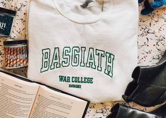 Basgiath War College sweatshirt with book, candles, and boots on patterned fabric