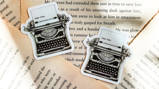 Vintage typewriter stickers on book pages, perfect for book lovers and readers.