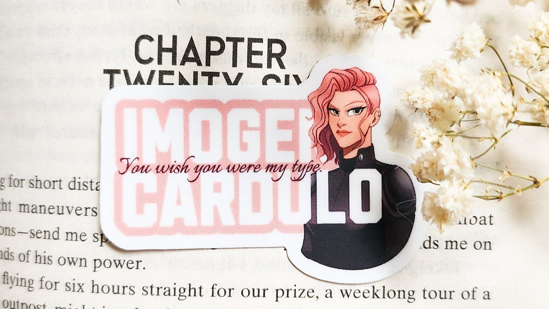Bookish sticker of pink-haired character Imogen Cardulo with quote, on open fantasy novel page.