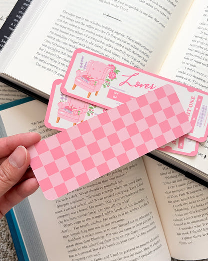 Pink checkered bookmarks with floral designs on an open book
