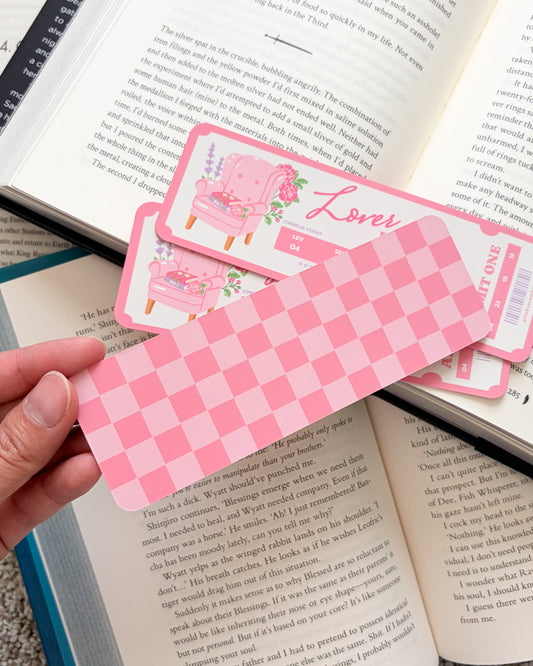 Pink checkered bookmarks with floral designs on an open book