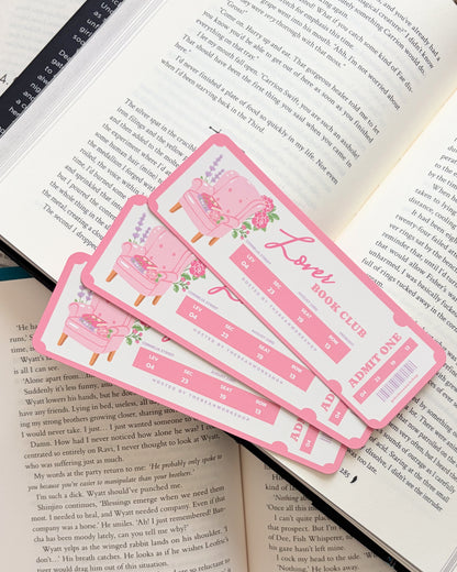 Pink bookmarks with floral designs on an open book