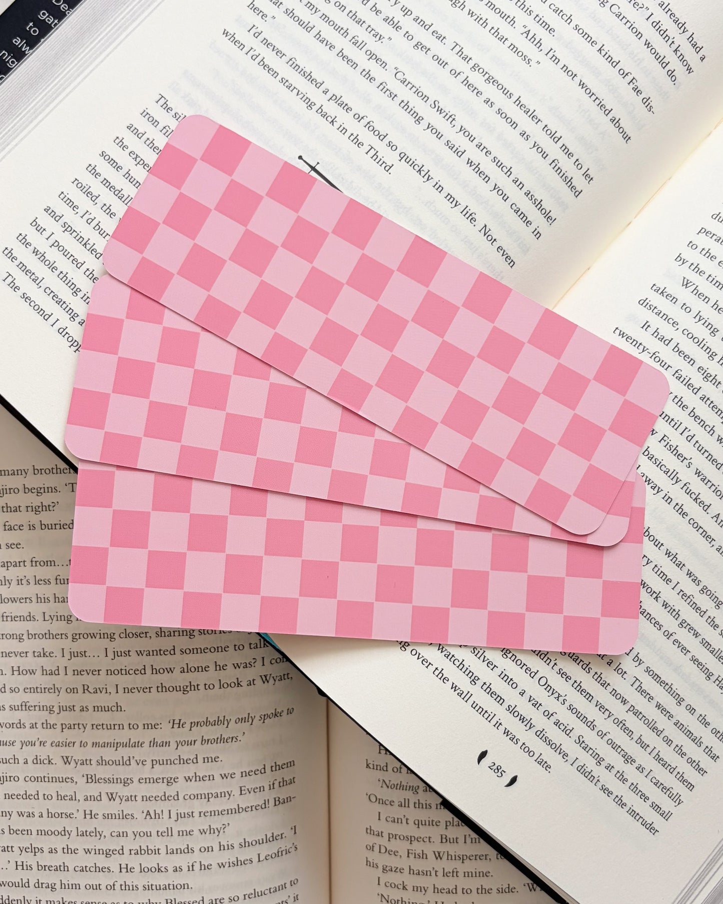 Pink checkered bookmark on an open book