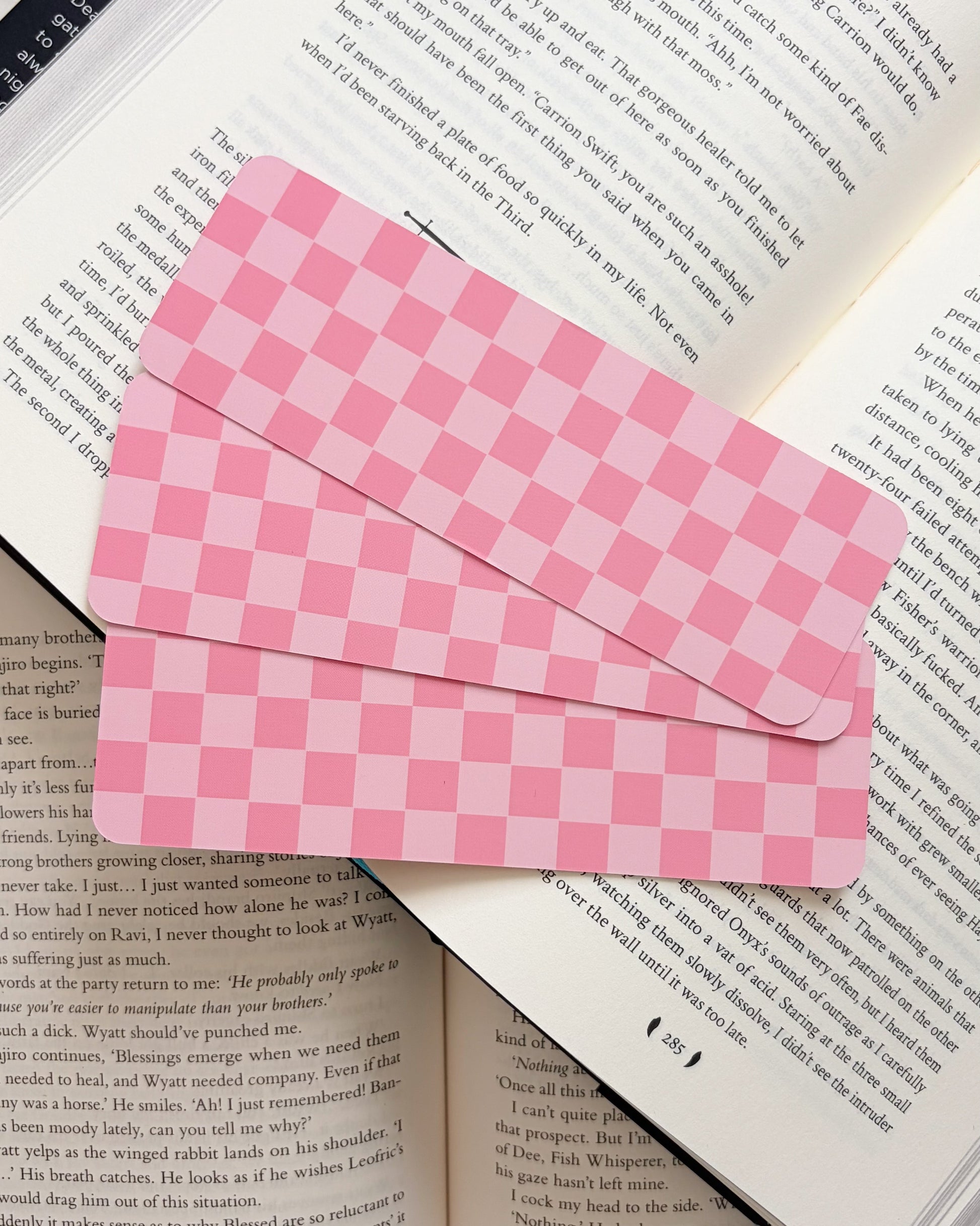 Pink checkered bookmark on an open book