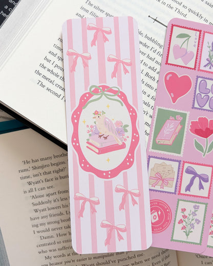 Decorative pink bookmarks with illustrations on an open book