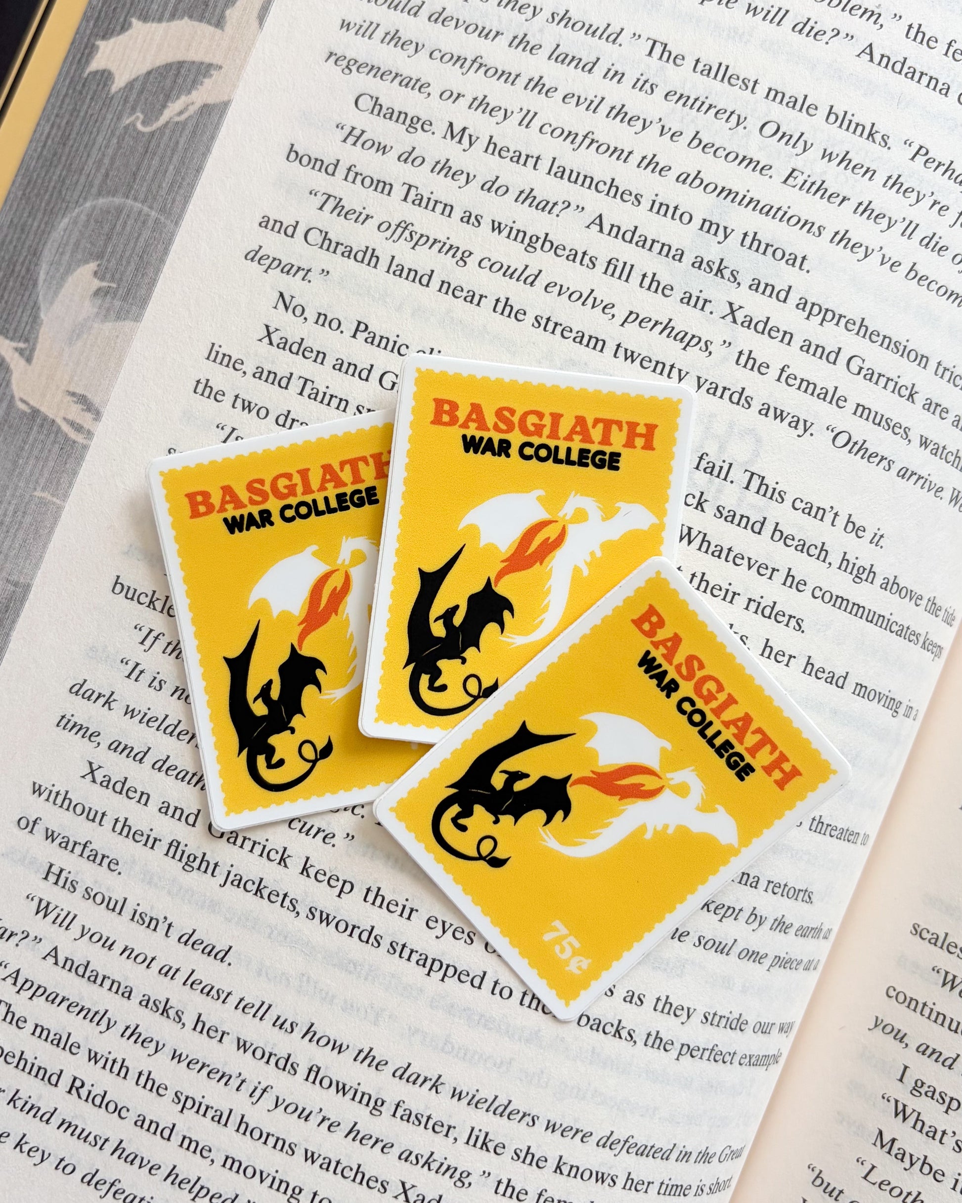 Book with 'Basilgia War College' stickers on an open book