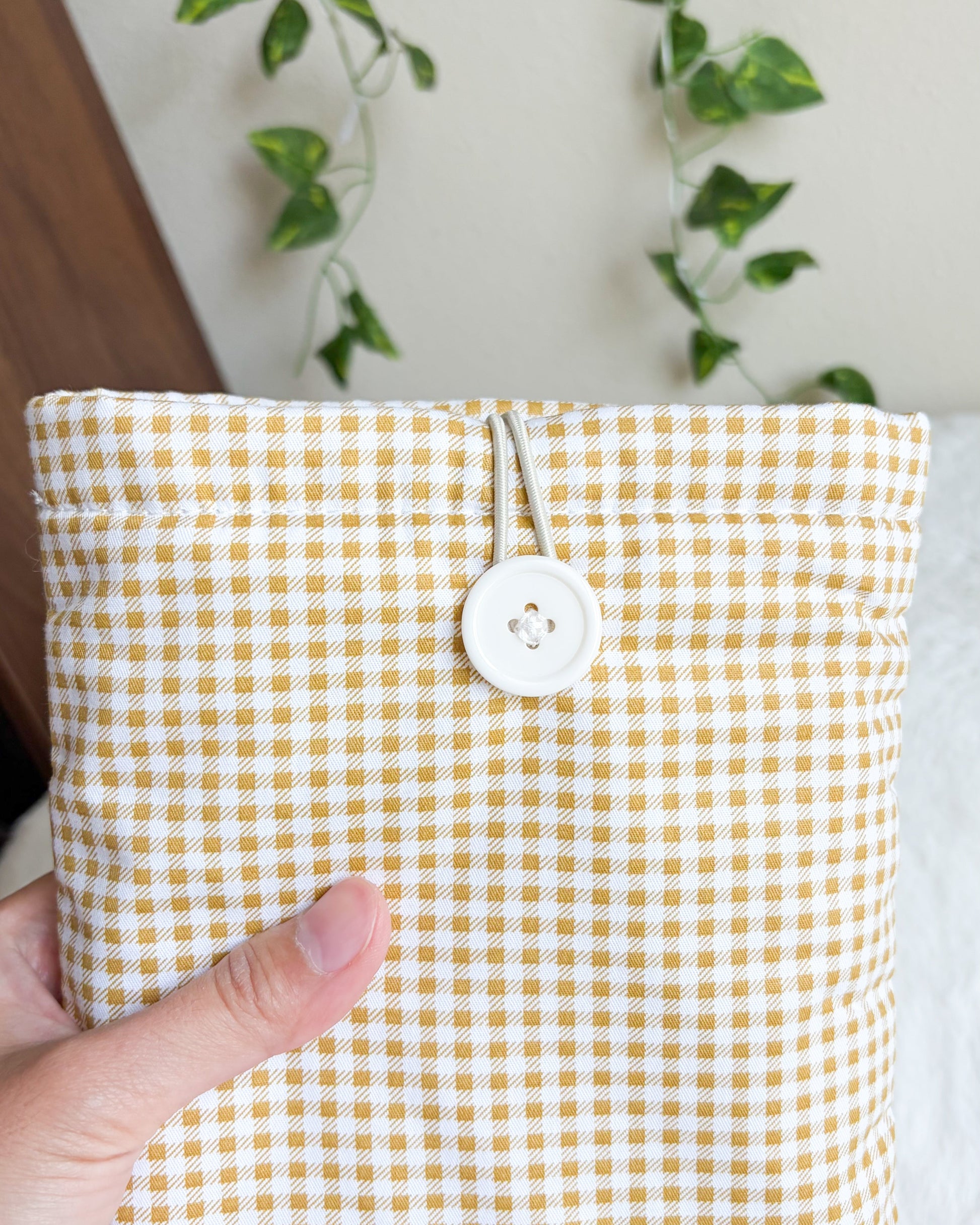 Golden gingham book sleeve front view with button closure detail