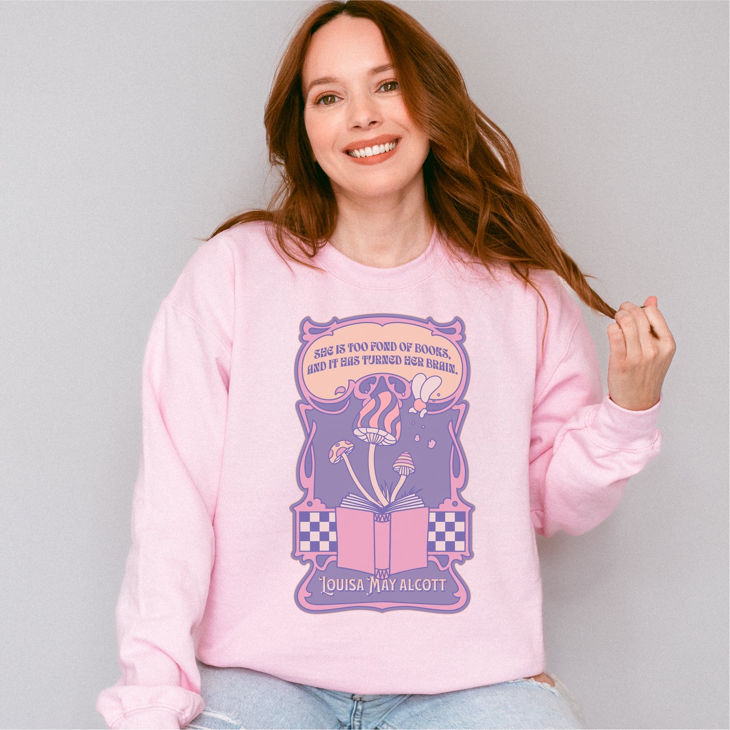 Woman wearing pink "She Is Too Fond of Her Books" Louisa May Alcott sweatshirt with bookish design