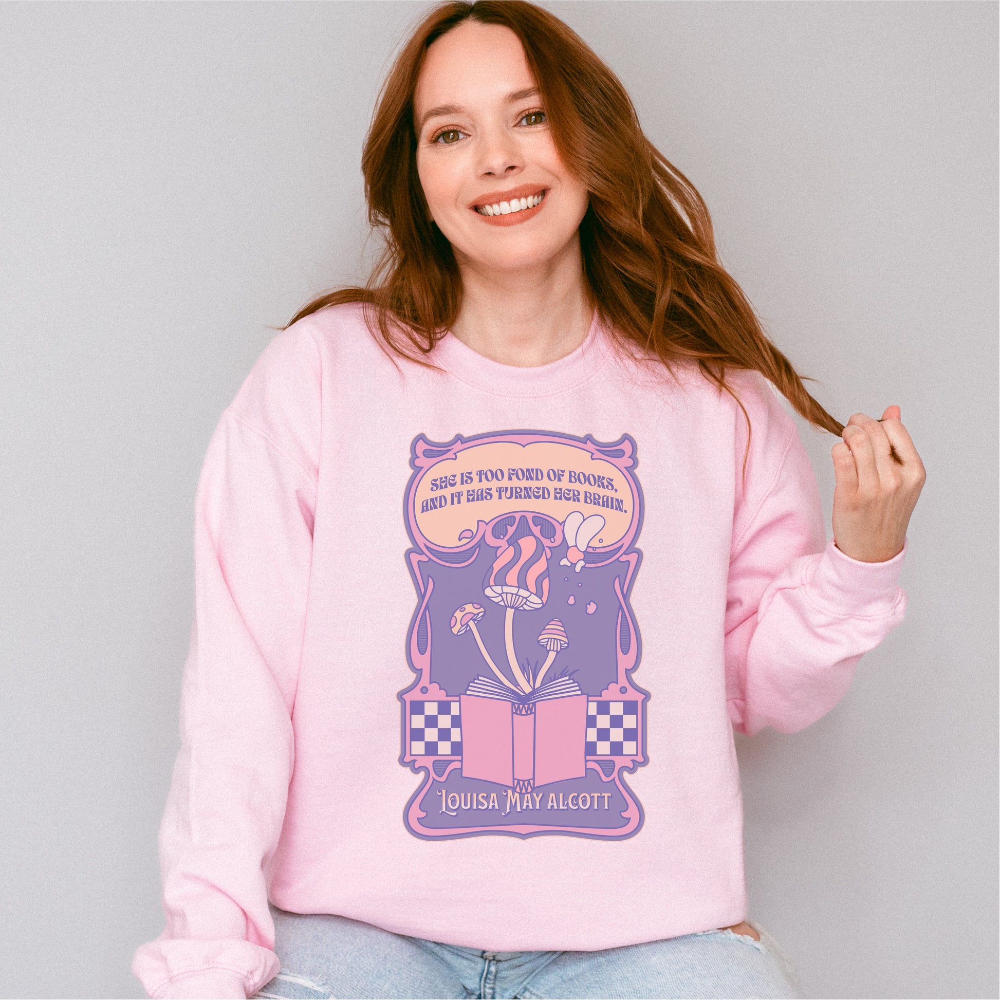 Woman wearing pink "She Is Too Fond of Her Books" Louisa May Alcott sweatshirt with bookish design