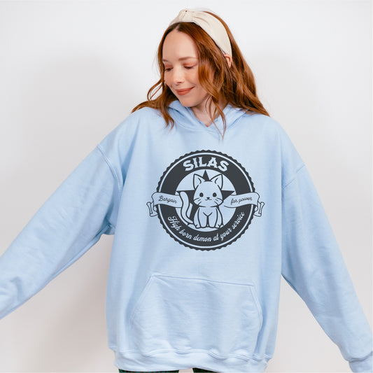 Light blue oversized hoodie with cute cat graphic and playful book-inspired text design