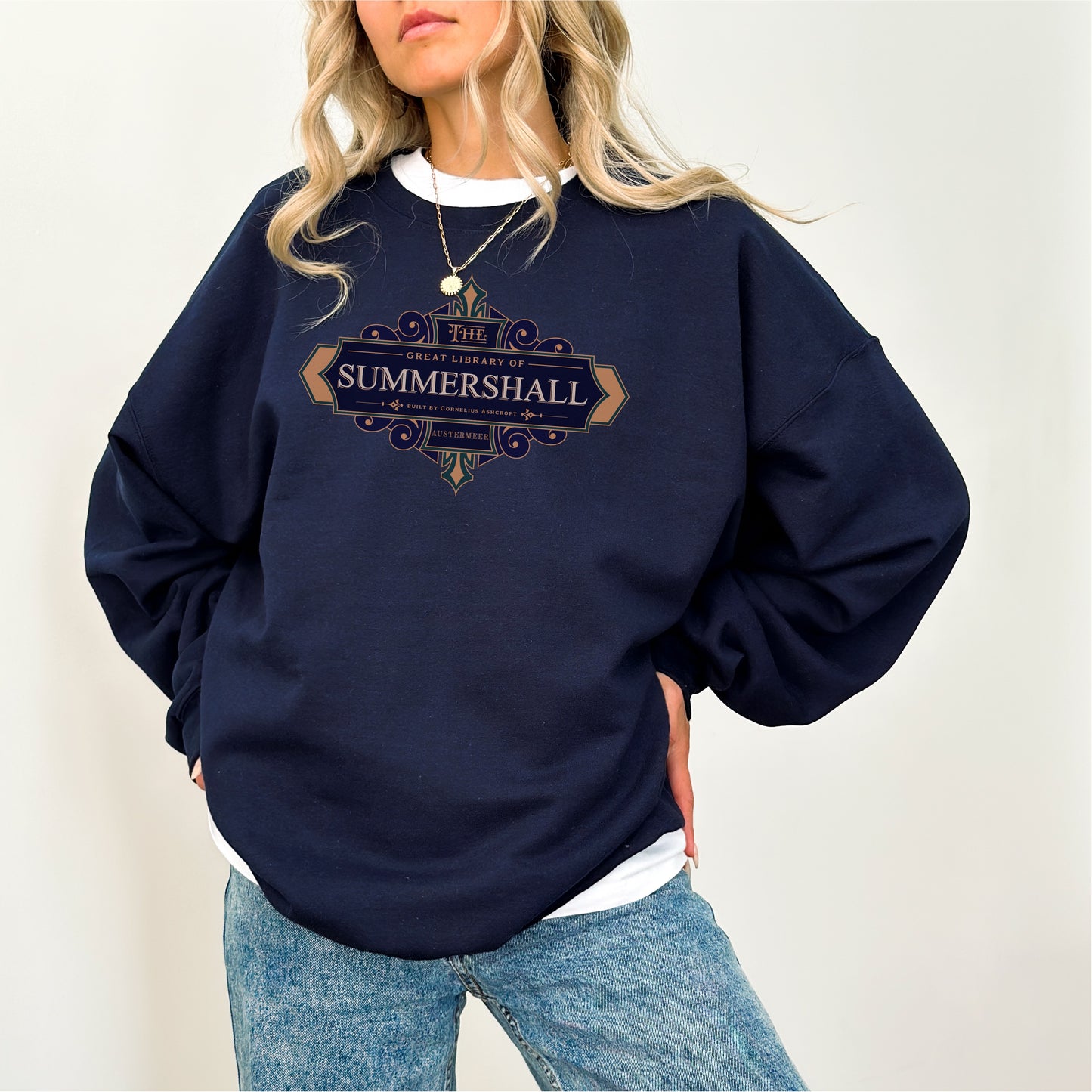 Navy Summershall Library sweatshirt with vintage-style lettering, worn by woman in jeans.