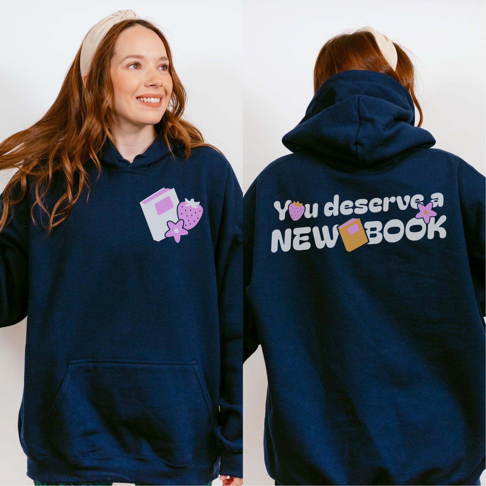 Navy blue book lovers hoodie with strawberry and book graphics, 'You deserve a NEW BOOK' text.