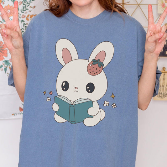 A Bunny Reading Her Book Tee Shirt - The Bean Workshop - animal shirt, book design, book lover gift, book t-shirt, bookaholic apparel, box tee, bunny t-shirt, cute book shirt, read everyday, reading bunny, Short n' Sweet Collection, t-shirt, tee