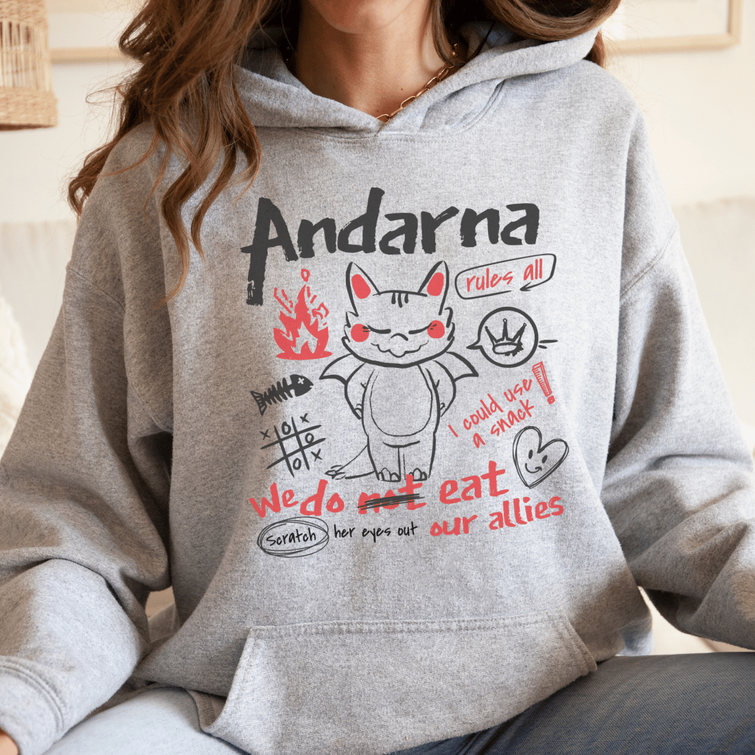 Grey hoodie featuring a cute dragon cartoon, doodles, and bookish Andarna text design.