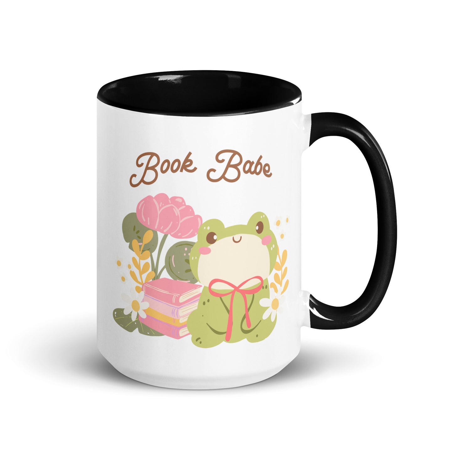 White ceramic mug with black handle, featuring 'Book Babe' text and cute frog, books, and flowers design