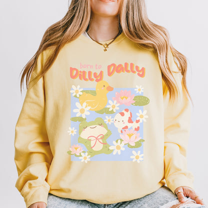 Yellow crewneck sweatshirt with cute frog, duck, and koi pond design, floral accents, and 'Born to Dilly Dally' text.