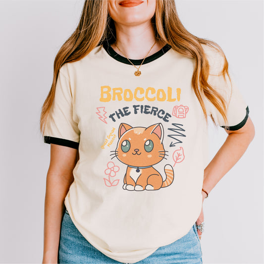 Cream ringer tee with cute cartoon orange cat and 'Broccoli the Fierce' bookish print