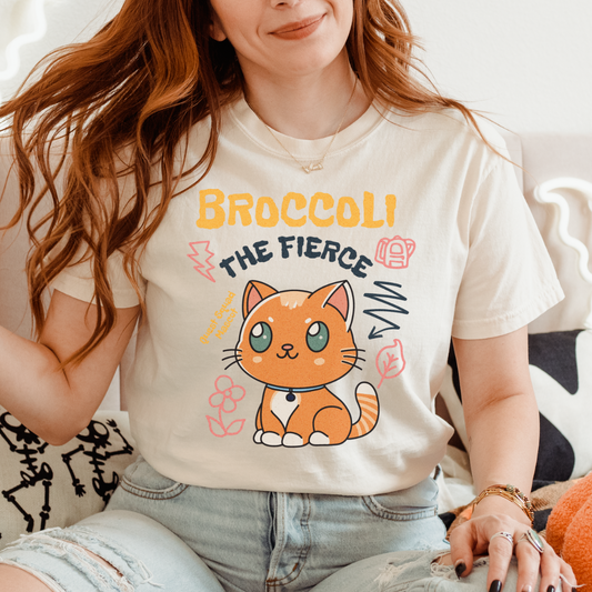Broccoli the Fierce T-Shirt - The Bean Workshop - Basgiath War College, Book Lover Gift, Bookish Cat, Booktok, Broccoli the Fierce, Chibi Art, Cute Romantasy, Dragon Rider, Empyrean Series, Fantasy Reader., Fourth Wing Merch, Iron Flame Merch, Kawaii, Liam Mairi, Quest Squad Mascot, Rebecca Yarros, t-shirt, Violet Sorrengail, Xaden Riorson