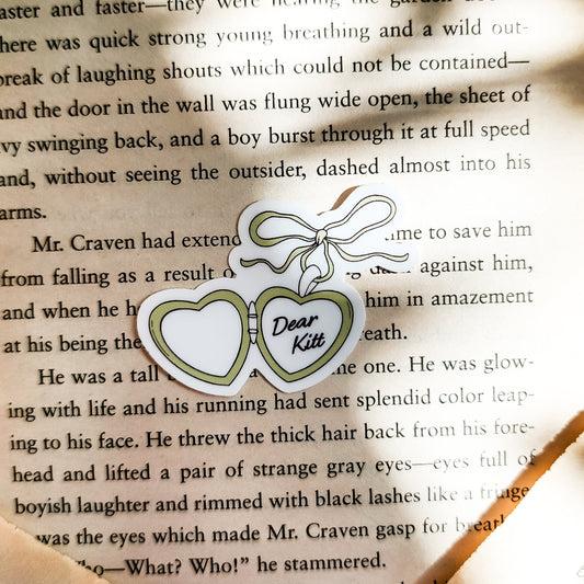 Dear Kitt Heart Locket Sticker | Divine Rivals Rebecca Ross - The Bean Workshop - bookish gift, bookish sticker, Dear Kitt, Divine Rivals, Divine Rivals merch, fantasy romance, gift for book lovers, Iris and Roman, journal sticker, laptop sticker, Letters of Enchantment, Rebecca Ross, Rebecca Ross fan merchandise, Rebecca Ross merch, Roman Kitt, Ruthless Vows, sticker