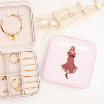 Pink jewelry travel case with romantic character illustration, gold rings and earrings organizer