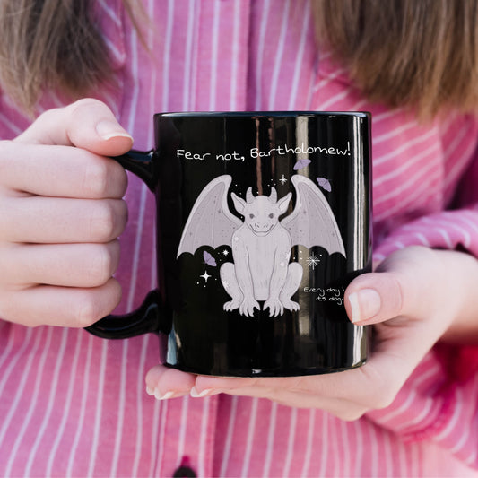 Fear Not Bartholomew Black Glossy Mug - The Bean Workshop - Bartholomew Winged Creature Illustration, Black Glossy Mug, Bookish Mug for Shepherd King Readers, Cozy Bookish Style, Fandom Drinkware, Fantasy Quote Mug, Fear Not Bartholomew Black Glossy Mug Fan Gift, Gift for Book Lovers, Lavender Grey on Black Design, Rachel Gillig, Reader Morning Mug, The Knight and the Moth, Whimsical Fantasy Aesthetic