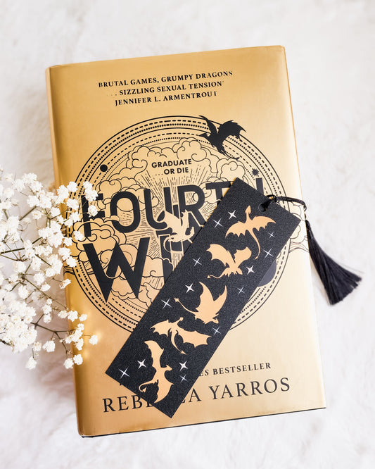 Fourth Wing book by Rebecca Yarros with black dragon-themed bookmark and tassel