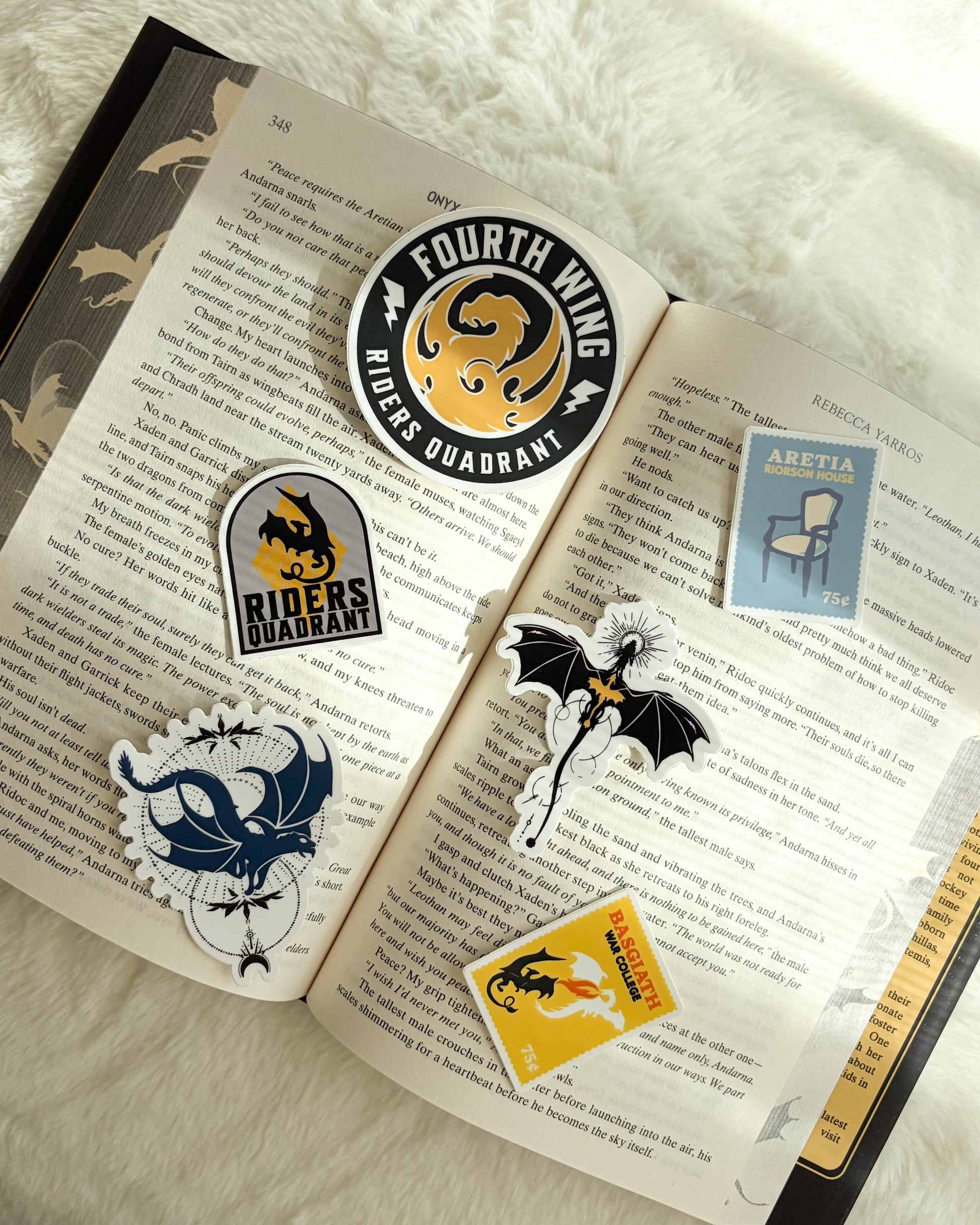 Collection of stickers on an open book with a soft white background