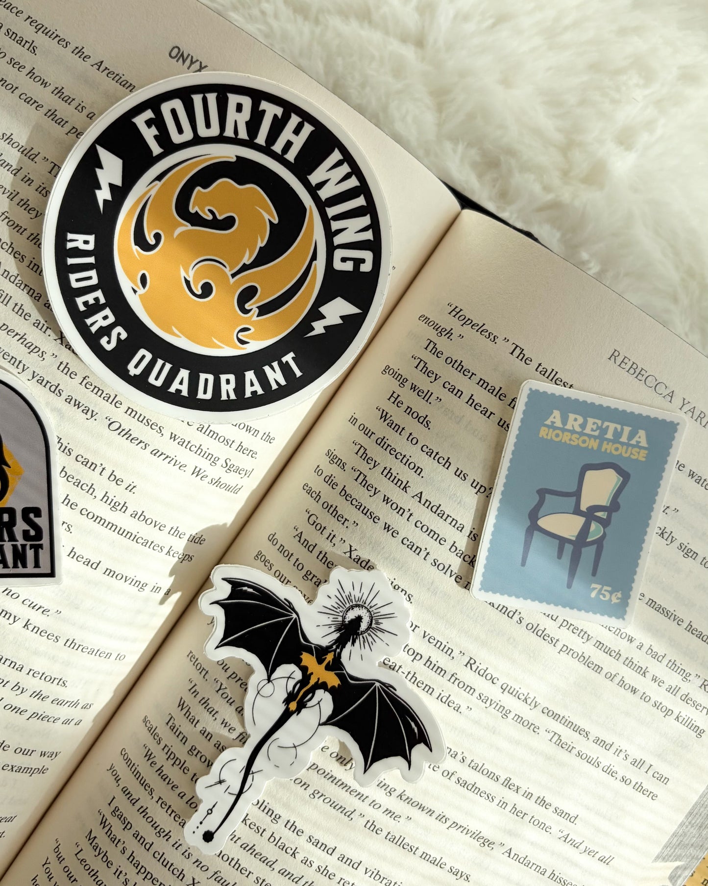 Stickers on an open book with a white fluffy background