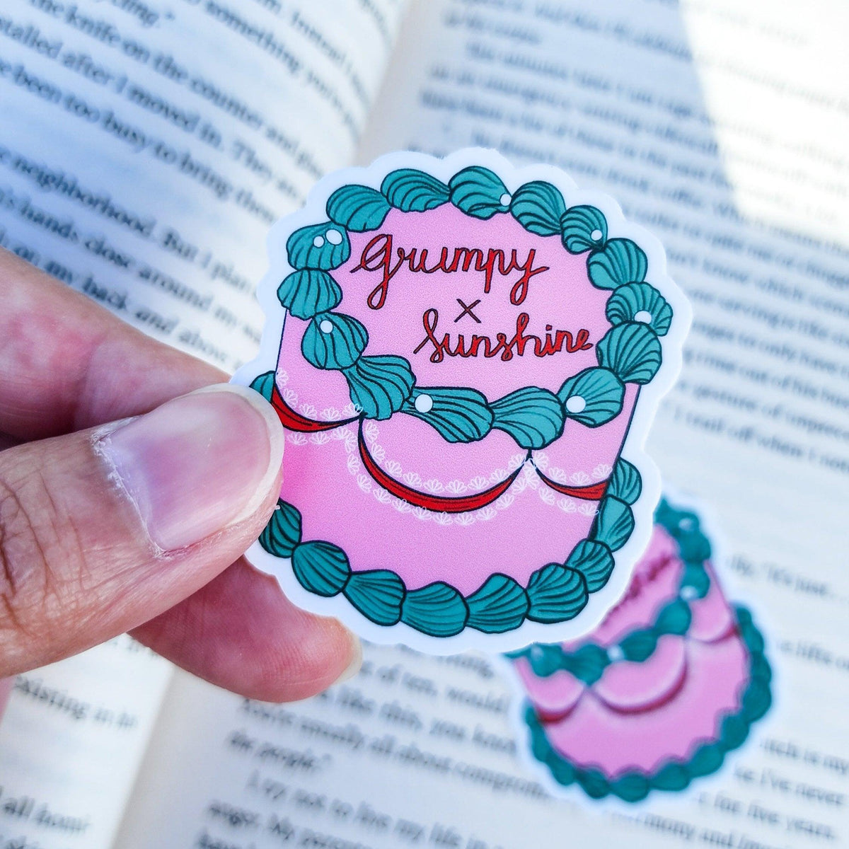 Grumpy x Sunshine Book Trope Retro Cake Sticker - The Bean Workshop - book lover gift, book trope, book trope sticker, Bookish Accessories, Bookish Gift, bookish sticker, coquette sticker, die cut sticker, grumpy sunshine, grumpy x sunshine, kindle sticker, reading sticker, retro cake sticker, romance reader, sticker