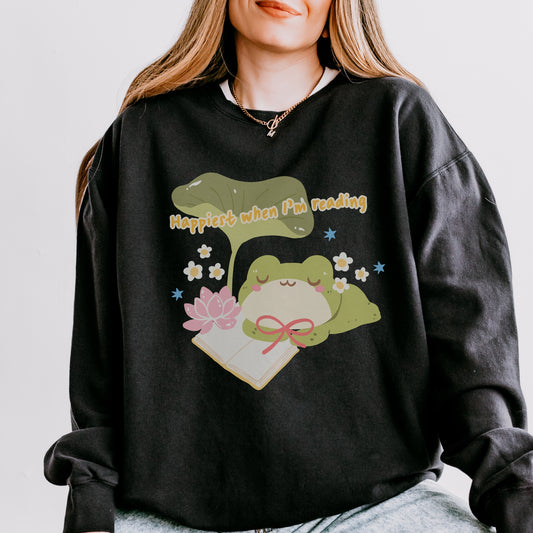 Black fleece crewneck sweatshirt with cute frog, book, flowers, and 'Happiest when I'm reading' text.