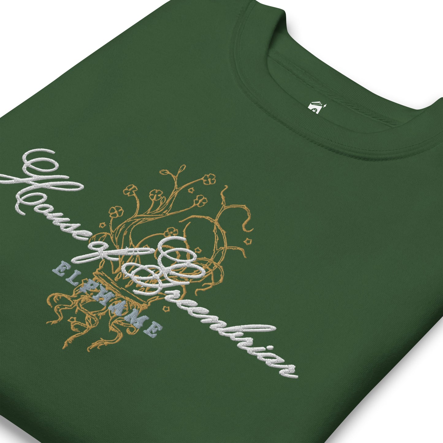 Close-up of forest green unisex sweatshirt with gold and white floral embroidery and script text.