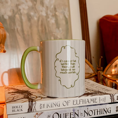 Bookish quote mug with green handle on stacked fantasy books in cozy reading nook