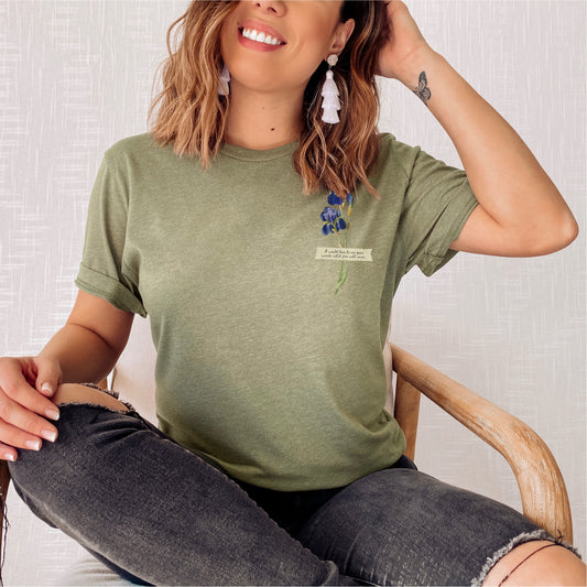 Woman wearing sage green t-shirt with flower and book quote, casual bookish apparel