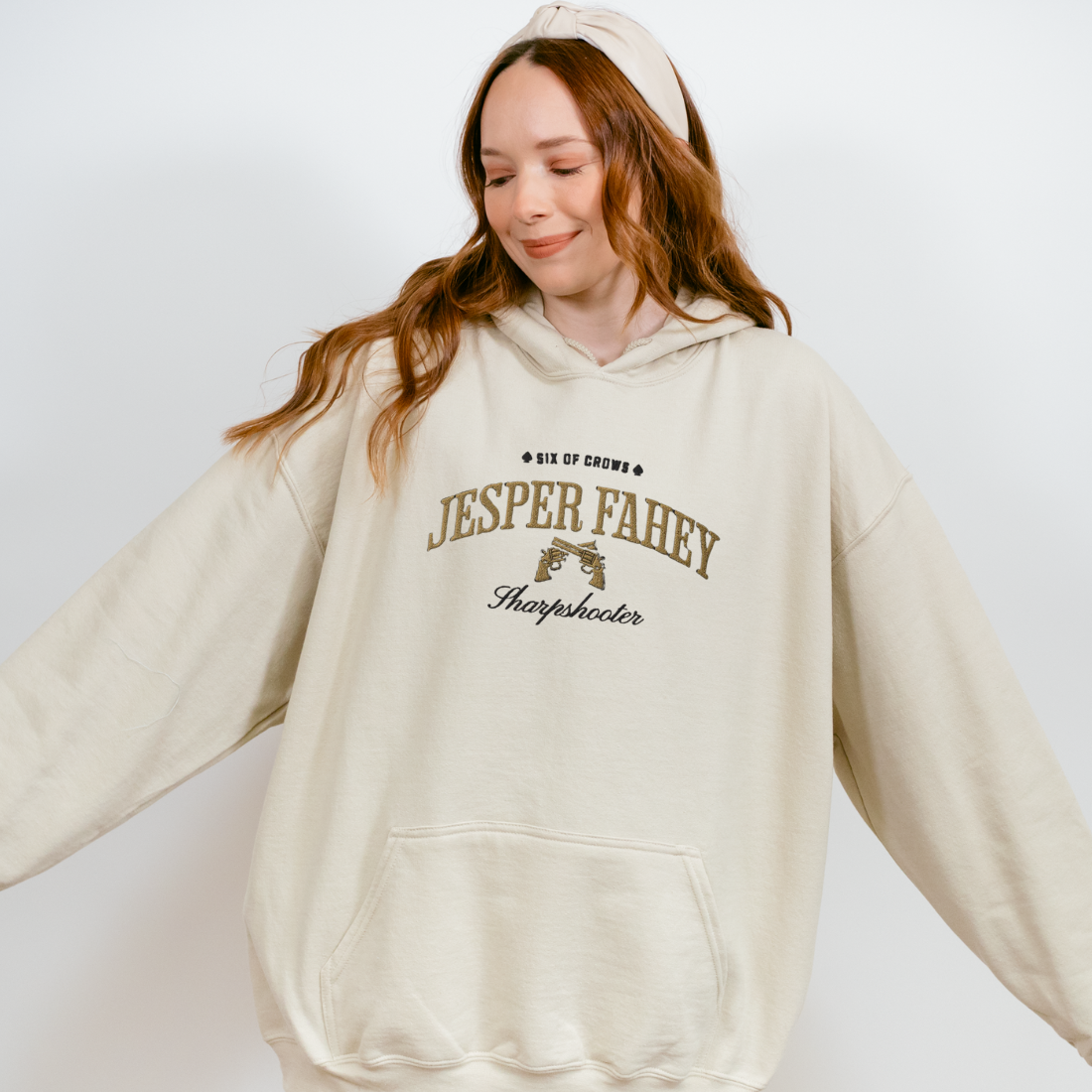 Jesper Fahey Embroidered Hoodie - The Bean Workshop - Bookworm Hoodie, Fandom Apparel, Grishaverse gift, Gunslinger Style, Jesper Fahey embroidered hoodie, leigh bardugo, Leigh Bardugo bookish hoodie for readers, Literary Streetwear, Revolver Design, Sharpshooter fan merchandise, Six of Crows hooded sweatshirt, The Dregs apparel, Wesper