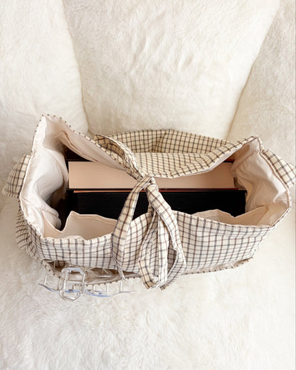 Large gingham book tote bag with multiple pockets, filled with books on a white background