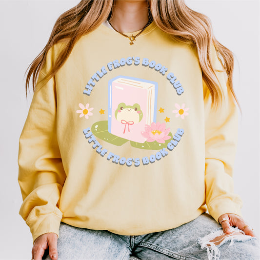 Yellow fleece sweatshirt with cute frog book club graphic, flowers, and pastel colors