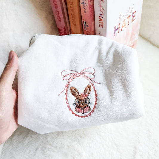 Little Rabbit and Her Book Zippered Pouch | Bookish Makeup & Reading Accessories Bag - The Bean Workshop - book girlie, bookish gift, bookish pouch, bow, coquette, coquette aesthetic, embroidered pouch, gift for book lovers, kindle bag, makeup bag, quilted pouch, rabbit book bag, reading accessories, reading accessories bag, zipper pouch