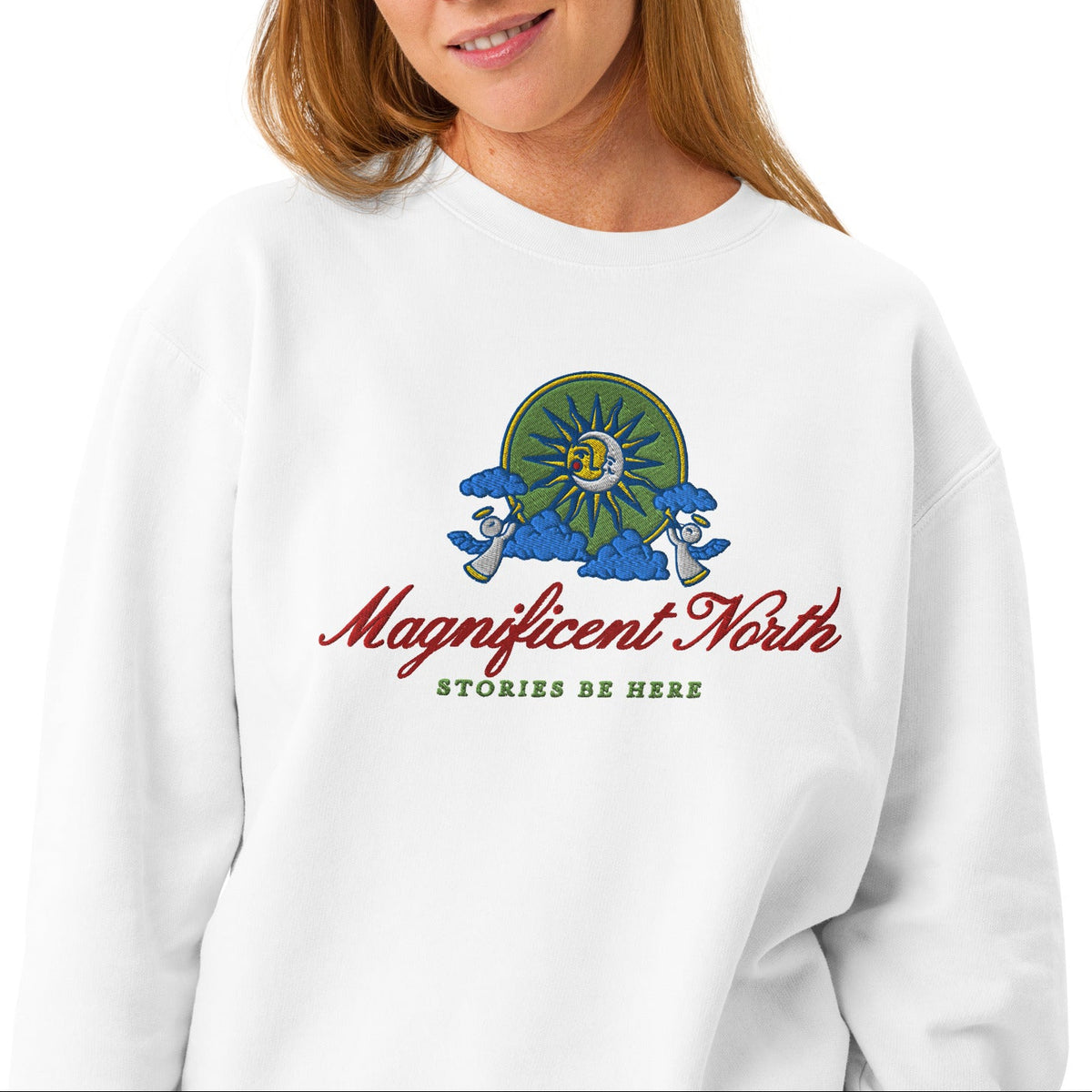 Magnificent North Embroidered Fleece Sweatshirt - The Bean Workshop - Cherub Trumpeter Detail, Cozy Loungewear, Embroidered Fleece Sweatshirt, Magnificent North Embroidered Fleece Sweatshirt for Book Lovers, Olive and Gold Color Palette, Once Upon a Broken Heart, Once Upon a Broken Heart Fan Gift, Stephanie Garber, Storybook Emblem, Sun and Moon Illustration, Travel Day Comfort, Whimsical Celestial