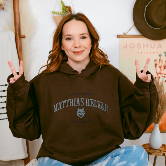 Matthias Helvar Embroidered Hoodie - The Bean Workshop - Bookworm Hoodie, Drüskelle fan merchandise, Fandom Apparel, Fantasy Character, Fjerdan Wolf, Grishaverse gift, Helnik, Leigh Bardugo literary merch, Literary Streetwear, Matthias Helvar embroidered hoodie, Minimalist Design, Six of Crows hooded sweatshirt, The Dregs apparel