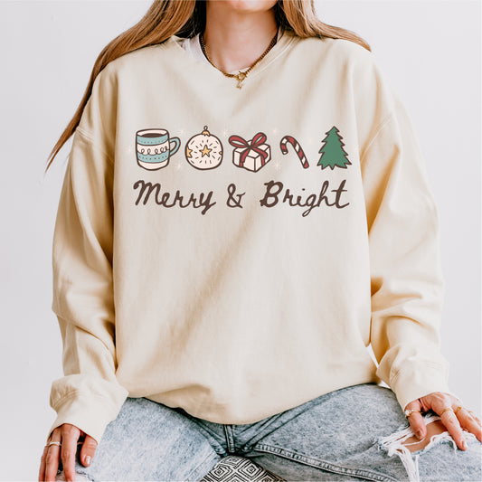 Cream fleece sweatshirt with holiday icons and 'Merry & Bright' text, cozy winter apparel.