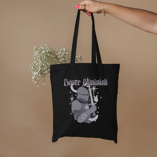 Never Diminish Organic Cotton Twill Tote Bag - The Bean Workshop - Bookish Tote Bag for Fantasy Readers, Dark Academia Aesthetic, Eco Tote Bag, Empowerment Quote Tote, Fandom Tote Bag, Gift for Fantasy Readers, Gothic Fantasy, Gothic Lettering Design, Greyscale Knight Illustration, Never Diminish Eco Tote Bag Shepherd King Fan, Rachel Gillig, Sustainable Bookish Bag, The Knight and the Moth