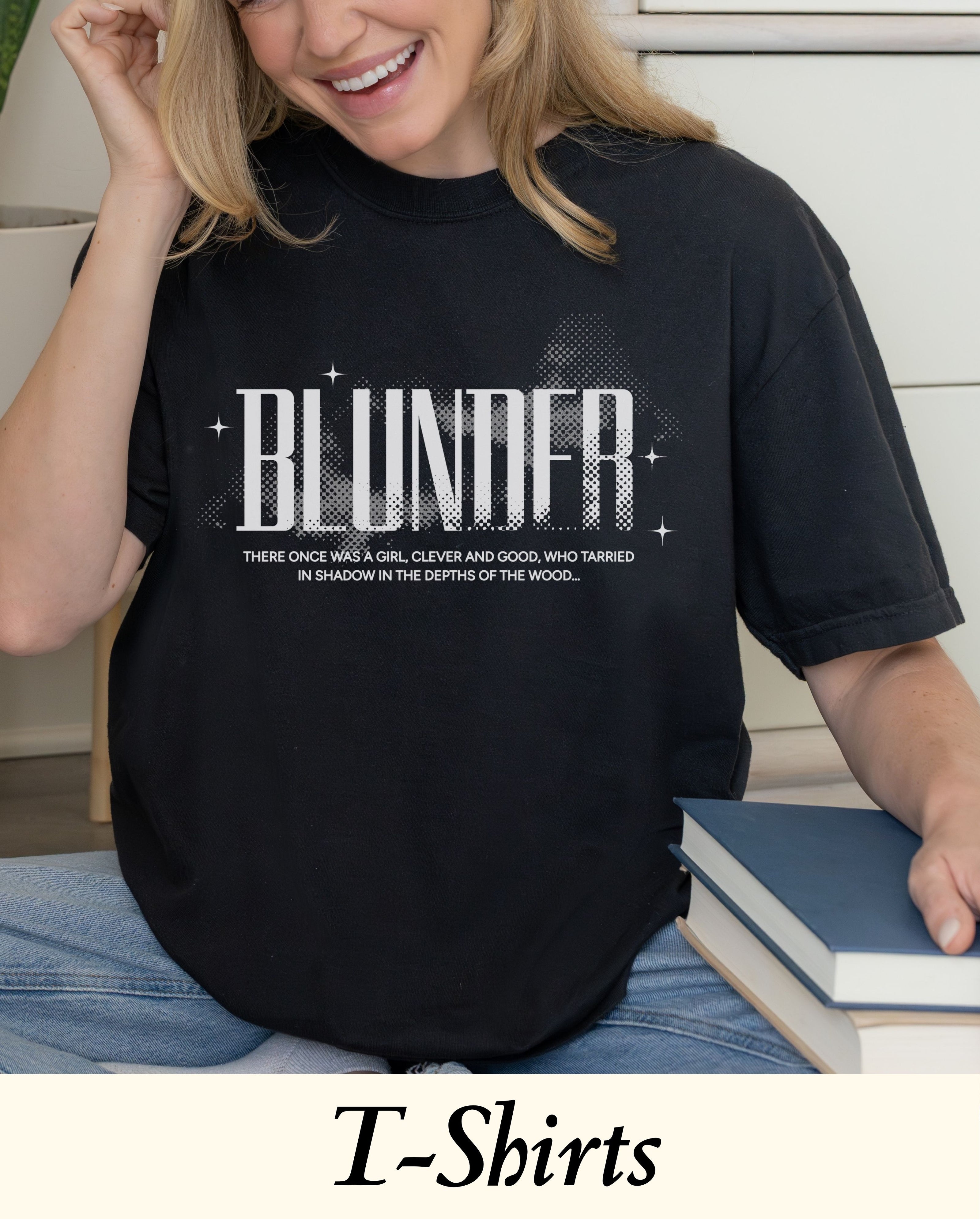An officially licensed Blunder gothic fantasy bookish merch t-shirt styled naturally with blue jeans, perfect for a cozy autumn BookTok reading time.