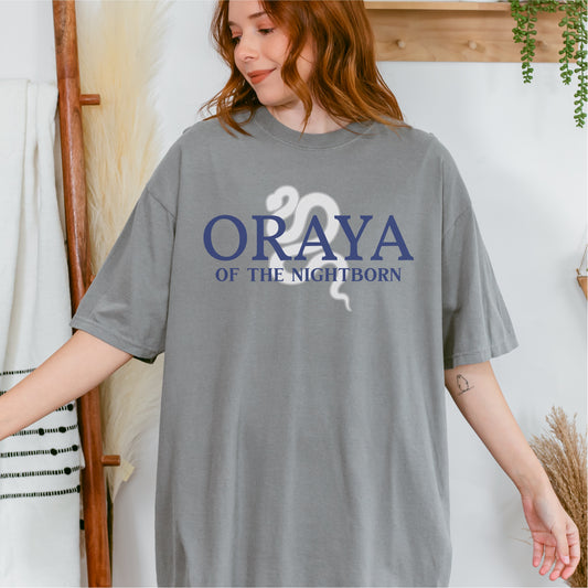 Woman wearing gray 'Oraya of the Nightborn' bookish t-shirt with snake graphic