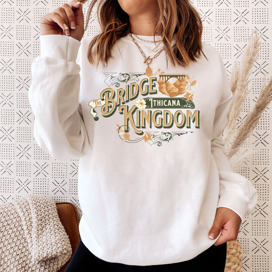 Woman wearing The Bridge Kingdom Ithicana art deco sweatshirt, cozy bookish loungewear