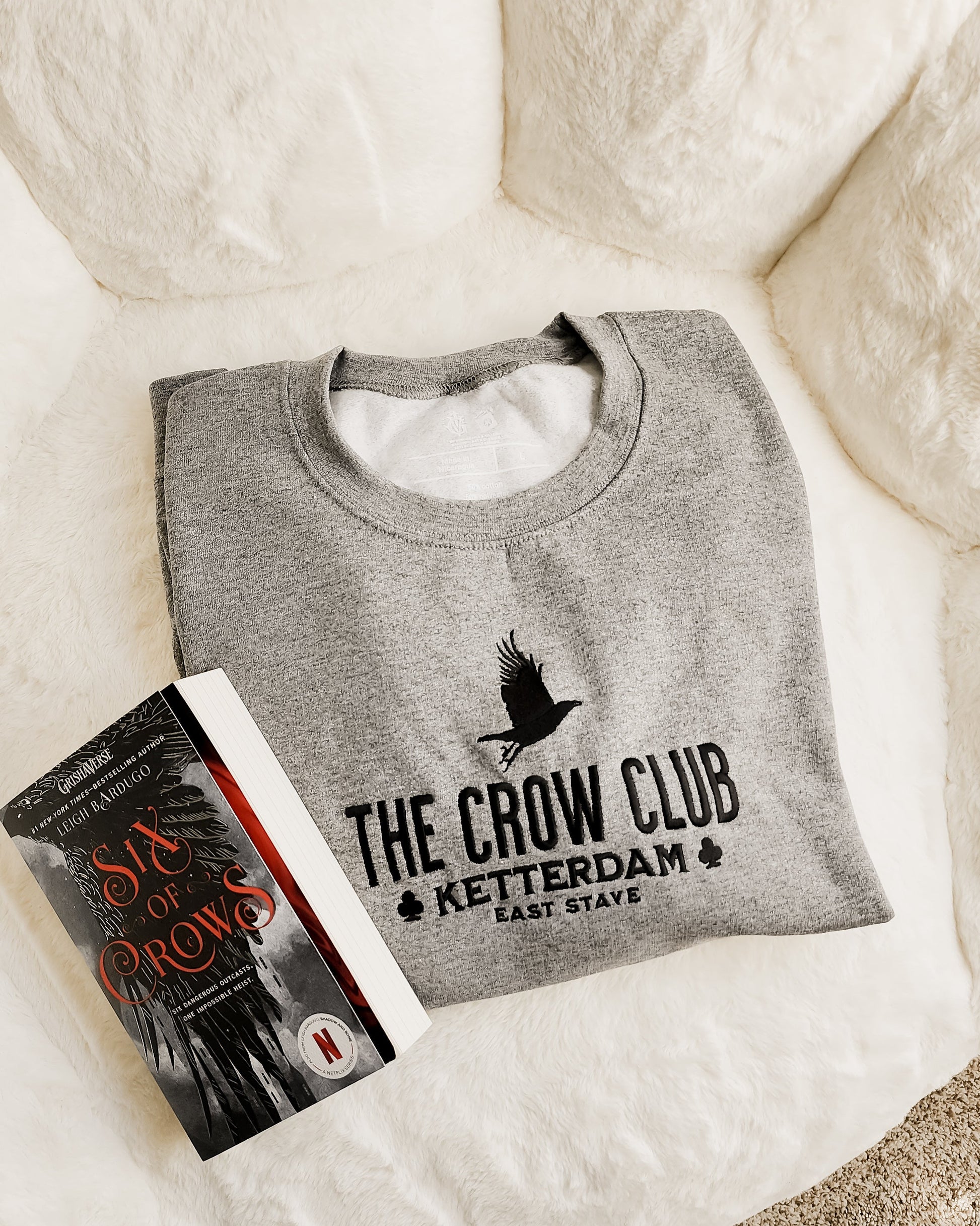 The Crow Club Embroidered Sweatshirt - The Bean Workshop - Book Lover Gift, Bookish Sweatshirt, Cozy Aesthetic, East Stave, Fantasy Book Merch, Grishaverse fan gift, Kaz Brekker, Ketterdam merch for readers, Leigh Bardugo bookish apparel, Literary Logo, Six of Crows cozy sweater, The Crow Club sweatshirt, The Dregs